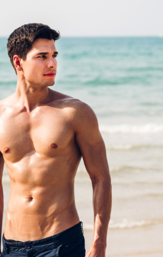Young, athletic man, walking with a naked torso by the sea