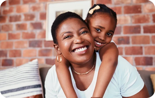 Mother smiling with her daughter after mommy makeover surgery | Ditesheim Cosmetic Surgery Charlotte