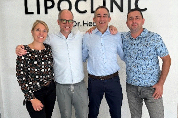group photo. Left to right: a woman, and then three men.